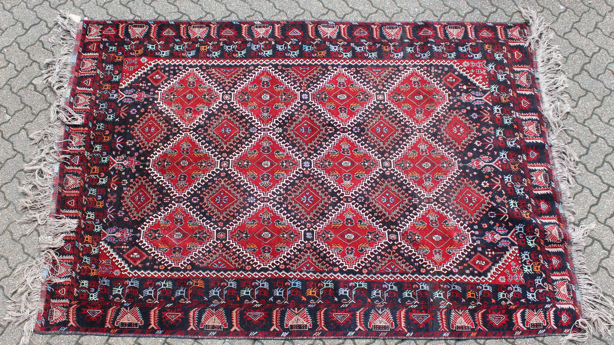 A LARGE PERSIAN CARPET with twenty main medallions 10ft long x 6ft 6ins wide.