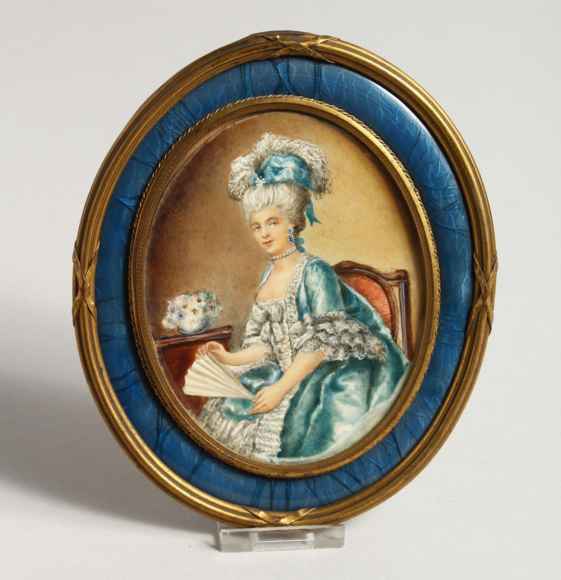 A VERY GOOD 19TH CENTURY FRENCH OVAL PORTRAIT OF A LADY holding a fan, in a blue enamel and ormolu