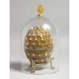 A REPLICA RUSSIAN FABERGE EGG on stand, with a dome.
