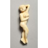 A CARVED BONE NUDE FEMALE FIGURE 3.5ins long