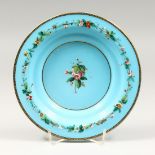 A VICTORIAN BLUE GLASS CIRCULAR OPALINE CIRCULAR PLATE, painted with flowers 8ins diameter.