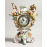 A CONTINENTAL PORCELAIN CUPID AND FLOWER ENCRUSTED CLOCK, with blue and white Roman numerals.