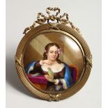 A GOOD CONTINENTAL CIRCULAR PORCELAIN PLAQUE, a girl with a parrot 3ins diameter in a gilt frame