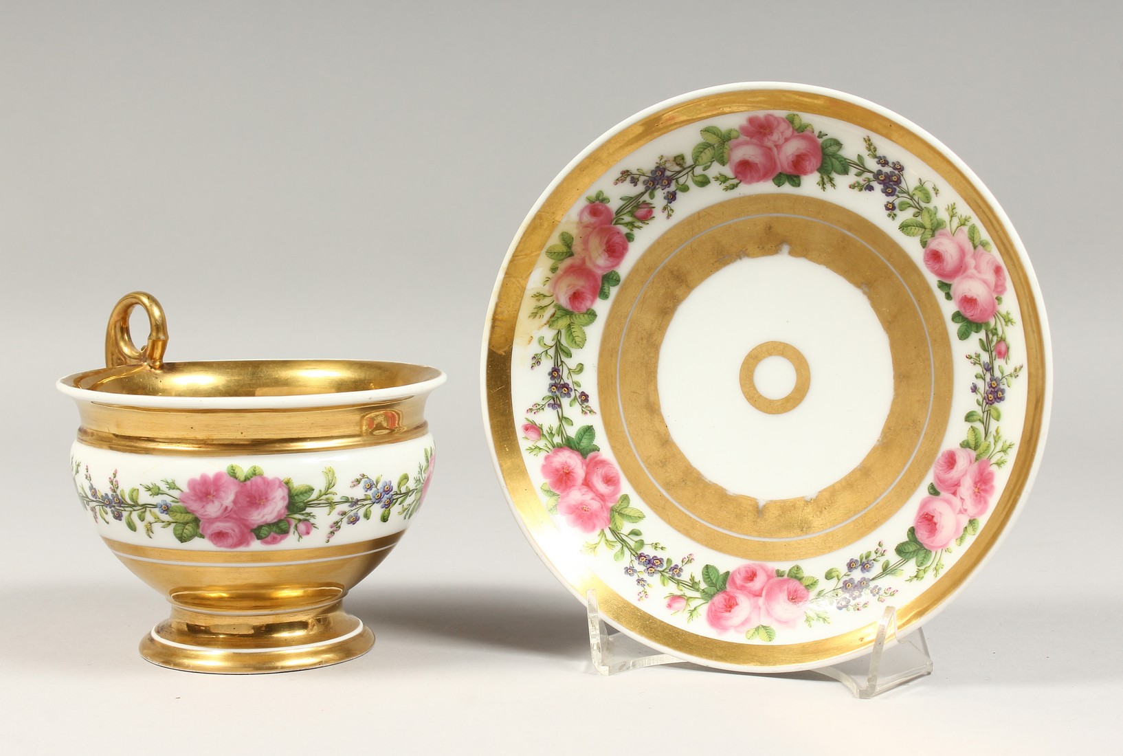 A LARGE PARIS PORCELAIN CUP AND SAUCER, with gilt and floral bands.