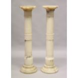 A GOOD PAIR OF ALABASTER CIRCULAR COLUMNS 3ft 7ins high.