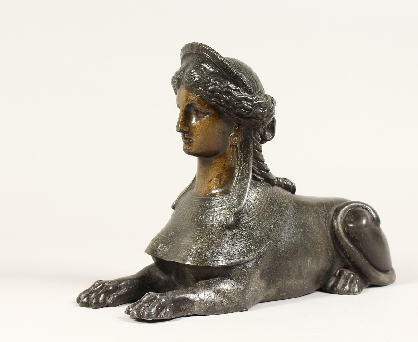 A SPELTER SPHINX 12ins long.