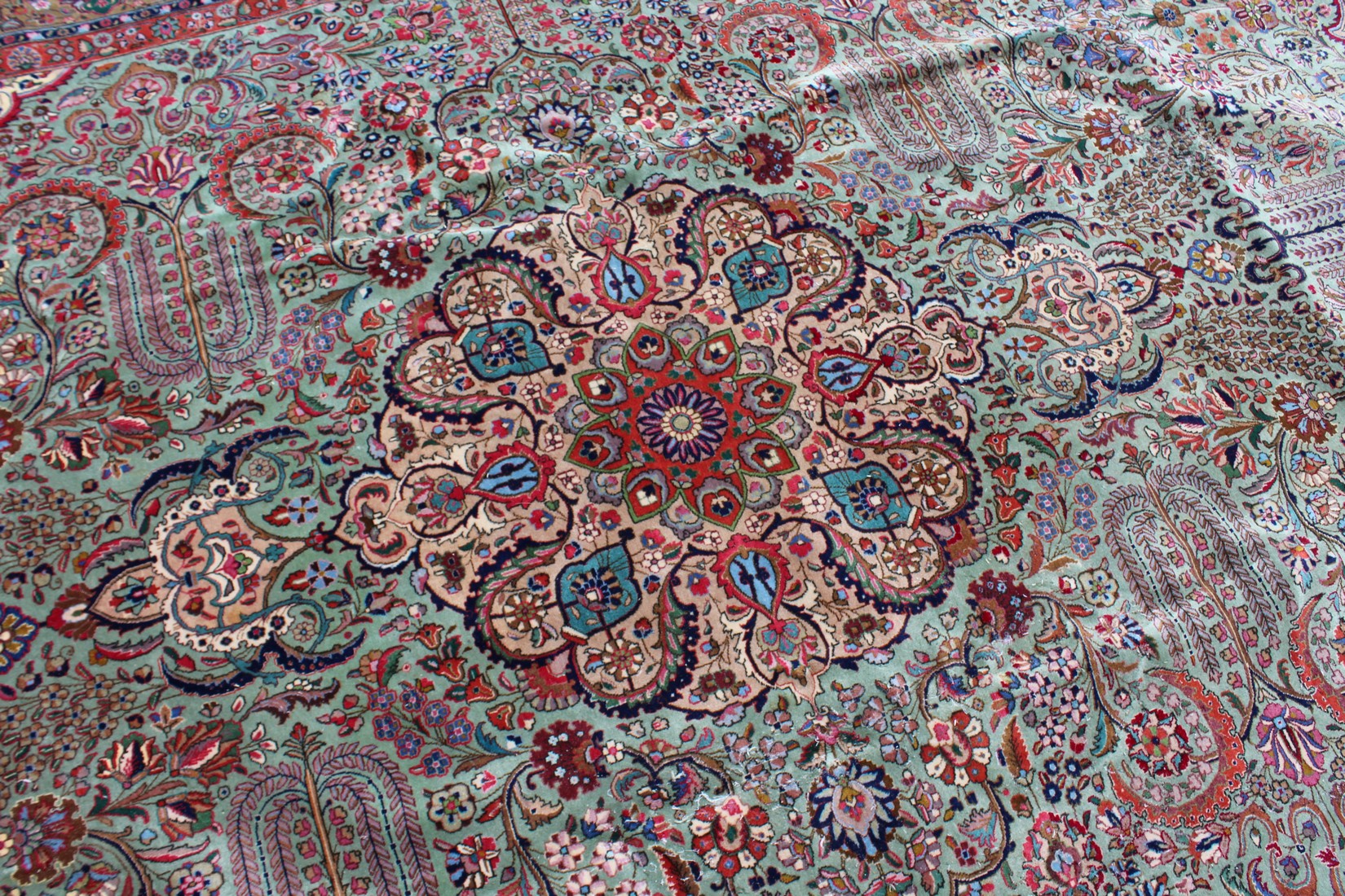 A LARGE PERSIAN TABRIZ CARPET, pale green ground with all over stylised floral decoration within a - Image 2 of 5