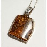 A SILVER AND AMBER PENDANT