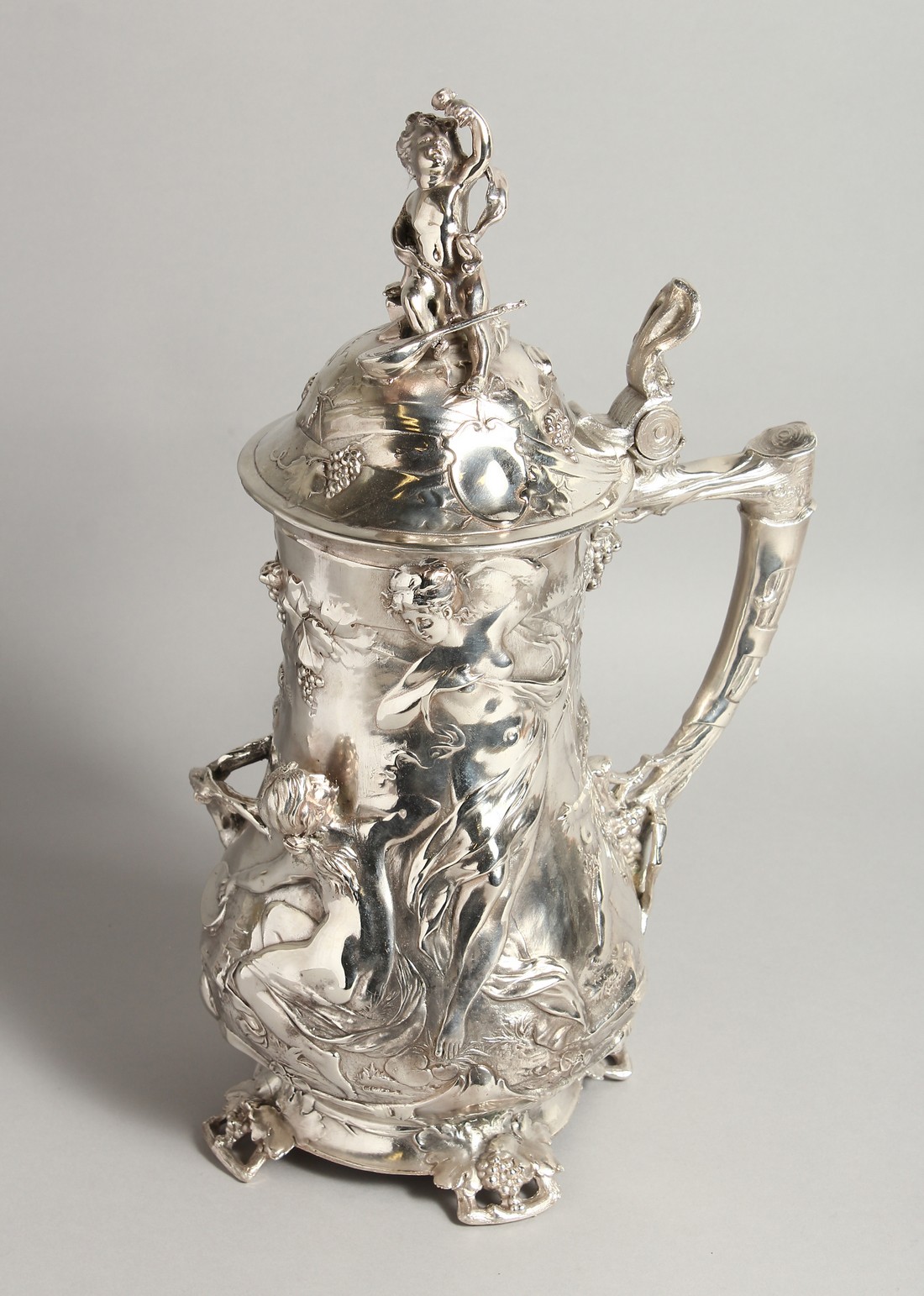 A GOOD W.M.F PLAIN TANKARD covered with classical repousse decoration. 16ins high.