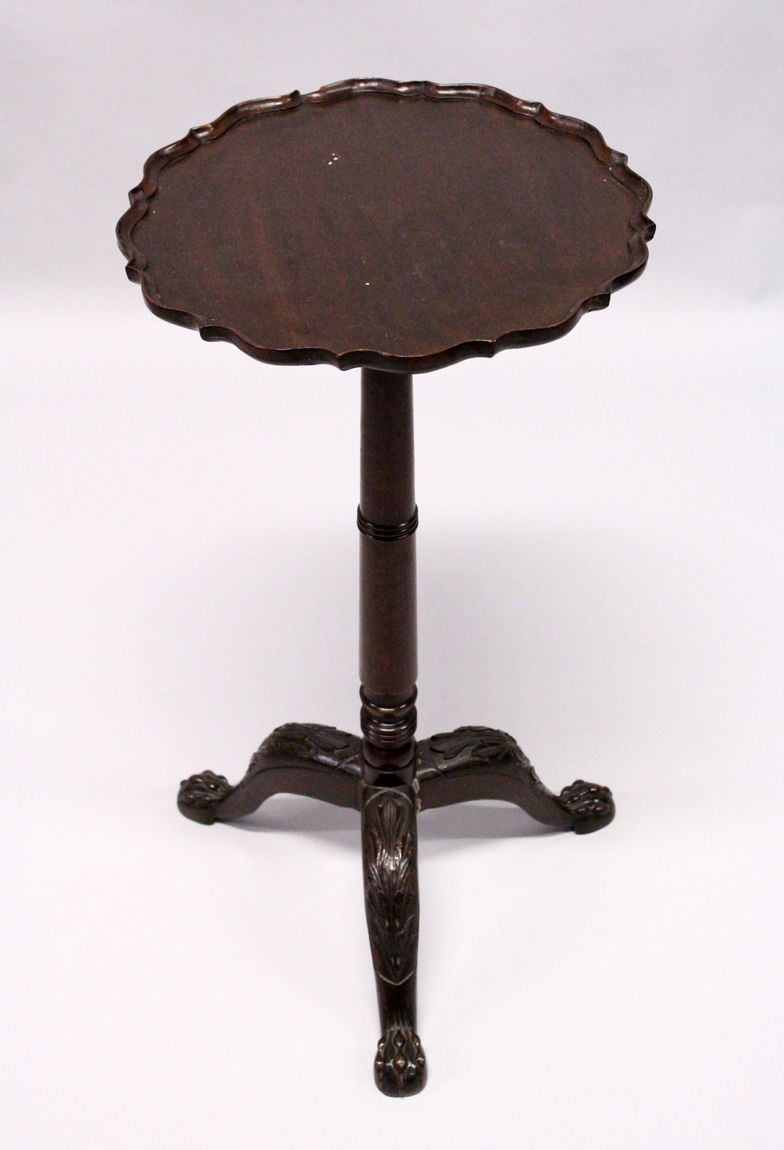 A GEORGE III DESIGN MAHOGANY TRIPOD TABLE, with pie-crust top, turned column on three carved legs