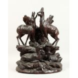 A GOOD 19TH CENTURY BLACK FOREST CARVED GROUP OF THREE DEER on a rocky base. 17ins high