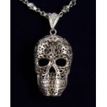 A SILVER SKULL ON A CHAIN.