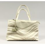 A RADLEY CREAM HANDBAG with dust cover