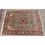 A LARGE PERSIAN TABRIZ CARPET, pale green ground with all over stylised floral decoration within a