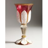 A BOHEMIAN RUBY, WHITE OVERLAY GOBLET with gilt decoration. 7.5ins high