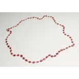 A GOOD 18CT GOLD RUBY SET CHAIN, set with four rubies