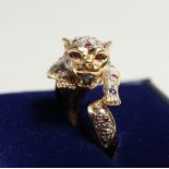 AN 18CT GOLD CARTIER DESIGN DIAMOND AND RUBY LEOPARD RING.