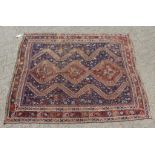 AN EARLY 20TH CENTURY KHAMESH RUG, dark blue ground with three central diamond shaped motifs. 6ft
