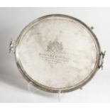 A LARGE GEORGE III TWO HANDLED TEA TRAY, 25ins long, with gadrooned edge, scrolling handles on 4
