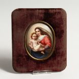 A 19TH CENTURY PORCELAIN MINIATURE MADONNA AND CHILD 3ins x 2.5ins in a velvet frame.
