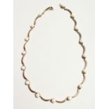 A 9CT. GOLD YELLOW GOLD AND PEARL NECKLACE 40cm long