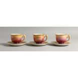 THREE ROYAL WINTON LUSTRE DECORATED PORCELAIN TEA CUPS AND SAUCERS, the handles moulded as birds.
