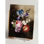 A GERMAN PORCELAIN PLAQUE painted with flowers. 9ins x 7.25ins