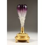 A CONTINENTAL AMETHYST TINTED GLASS VASE with gilded metal base 12ins high.