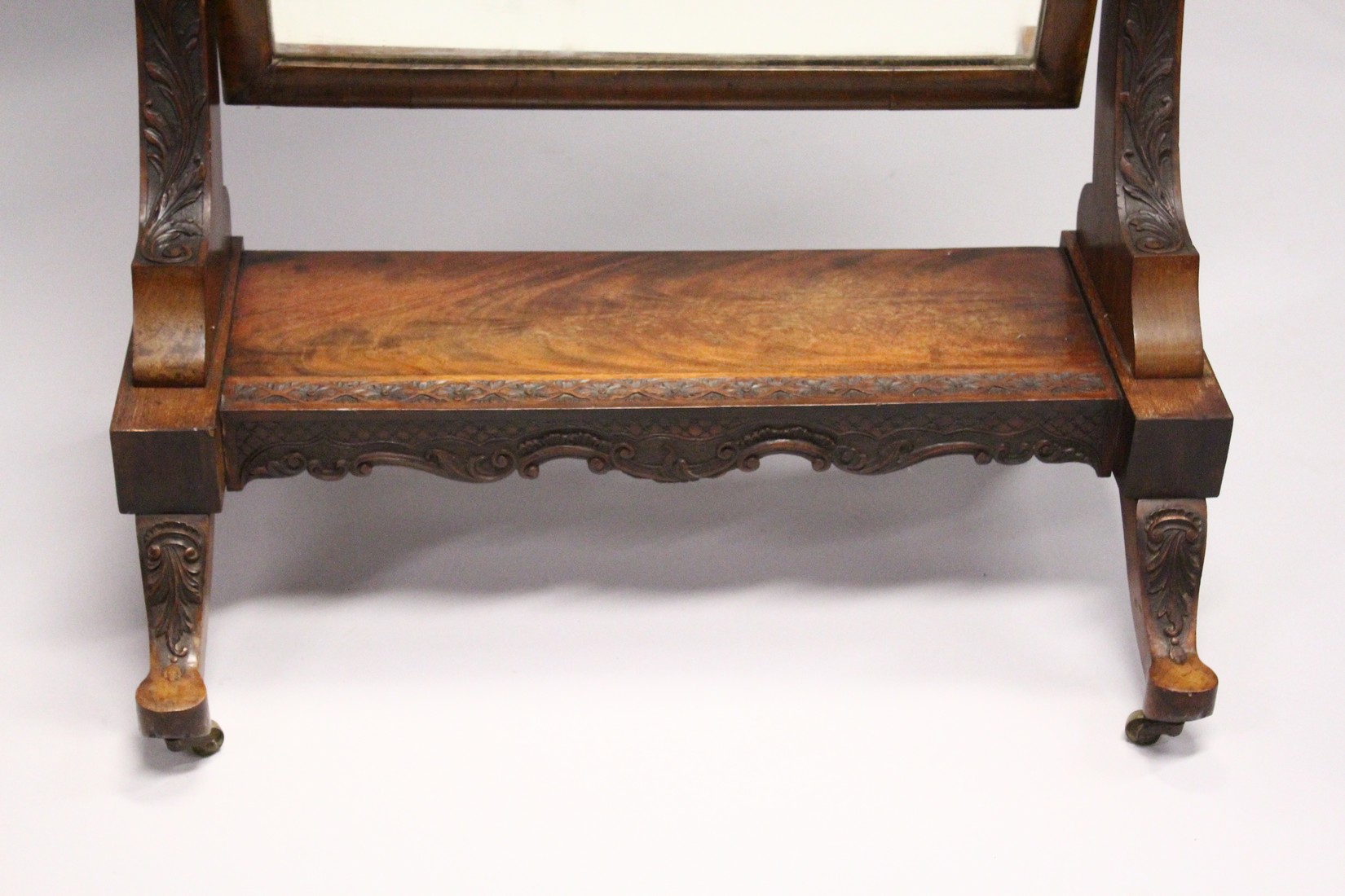 A GOOD IRISH CARVED MAHOGANY CHEVAL MIRROR, mirrored plate, the stand ending on castors. 4ft x 2ft - Image 3 of 5