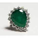 A SUPERB 18CT WHITE GOLD, PEAR CUT EMERALD AND DIAMOND RING set with a large emerald surrounded by
