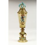 A GERMAN GREEN TINTED VASE AND COVER painted with a man carrying a sword. 16ins high.