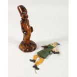 A CARVED TREEN FIGURAL PIPE and stand, 8.5ins high, and a puppet (2)