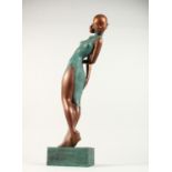 AN ABSTRACT BRONZE, STANDING FEMALE FIGURE. 26ins high