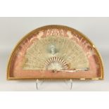 A FRAMED AND GLAZED FRENCH FAN in lace over mother of pearl 13ins x 22ins