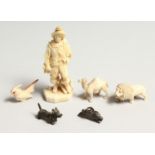 A SMALL EUROPEAN CARVED IVORY MAN CARRYING A HORN 3ins high and a lion, a camel, bird, and dog. (5)