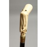 A WALKING STICK WITH A CARVED BONE OCTOPUS HANDLE 34ins long