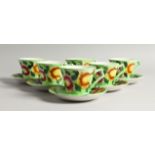 A SET OF SIX MALING PORCELAIN COFFEE CUPS AND SAUCERS, green ground, painted with flowers, pattern