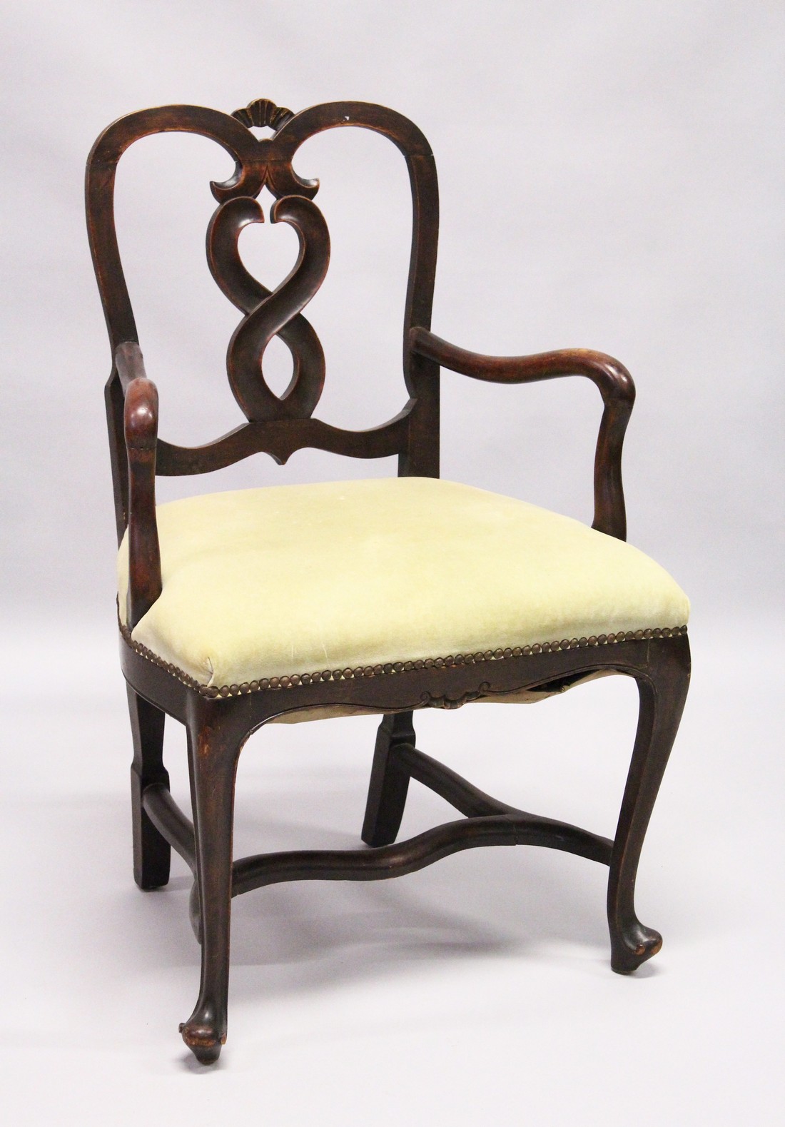 A SMALL GEORGE II DESIGN MAHOGANY OPEN ARMCHAIR with curved cresting, wavy splats, shepherd’s