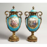A SUPERB LARGE PAIR OF SEVRES PORCELAIN ORMULO MOUNTED CIRCULAR VASES AND COVERS, painted with