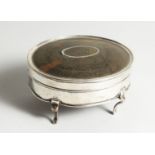 A GEORGE V SILVER AND TORTOISESHELL OVAL PIN BOX on four curving legs. 4.75ins long, London 1912.