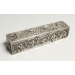 A BURMESE SILVER LONG BOX AND COVER with figures in relief 7ins long