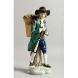 A SAMSON CHELSEA DERRY PORCELAIN FIGURE of a man, a basket of flowers on his back 9ins high.