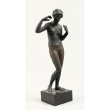 AFTER THE ANTIQUE, A PAINTED MOULDED PLASTER FIGURE OF A STANDING FEMALE NUDE, on a square base