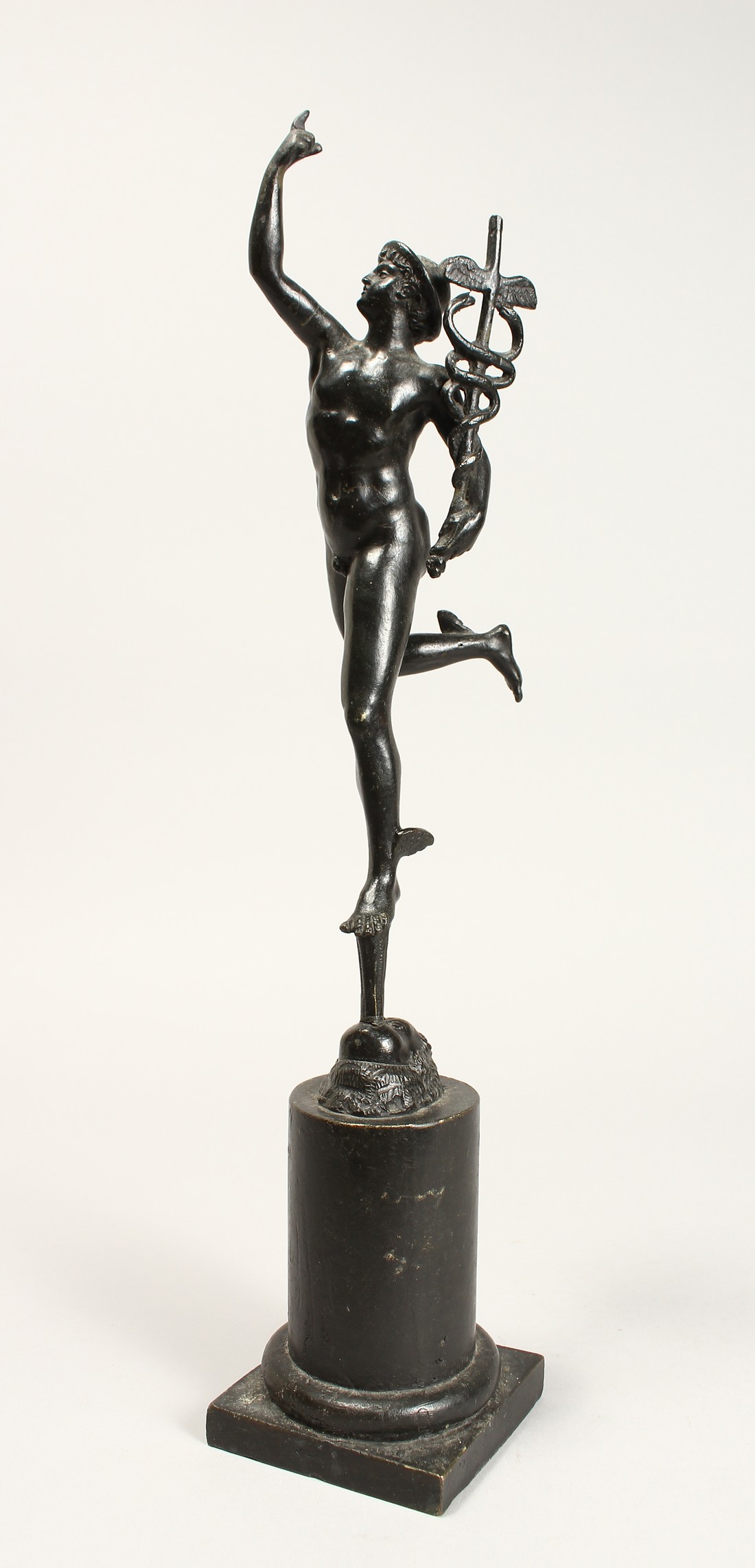 AFTER THE ANTIQUE A BRONZE OF MERCURY 12ins, on a plinth.