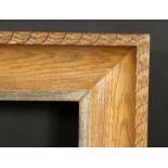 A carved oak frame with silvered inner ornaments, rebate size 24 x 36 , 61cm x 92cm.