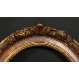 A 19th century oval frame with flowered cartouches and incised scrolling, rebate size 19.25 x 15 ,