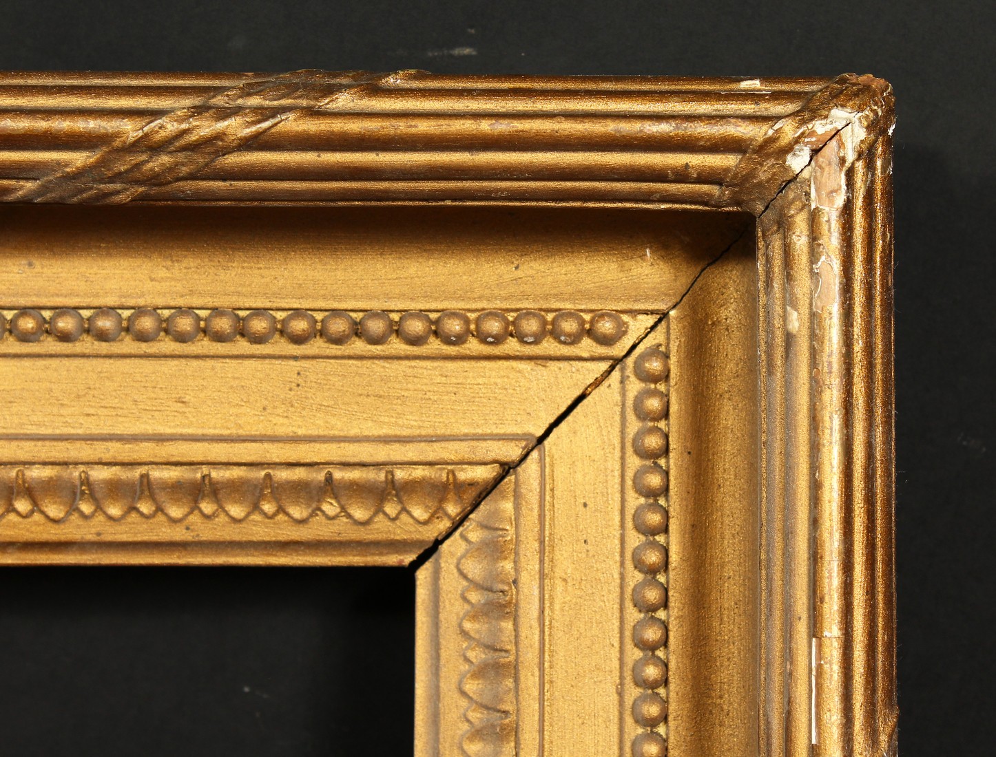 A 19th century gilt composition frame with moulded and ribbon tied top ornament, rebate size 13 x