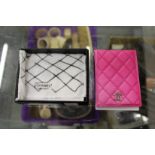 A pink quilted leather credit card case.