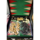 A back gammon box containing various gaming items.