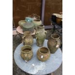 Terracotta and stoneware pots and two old copper saucepans.